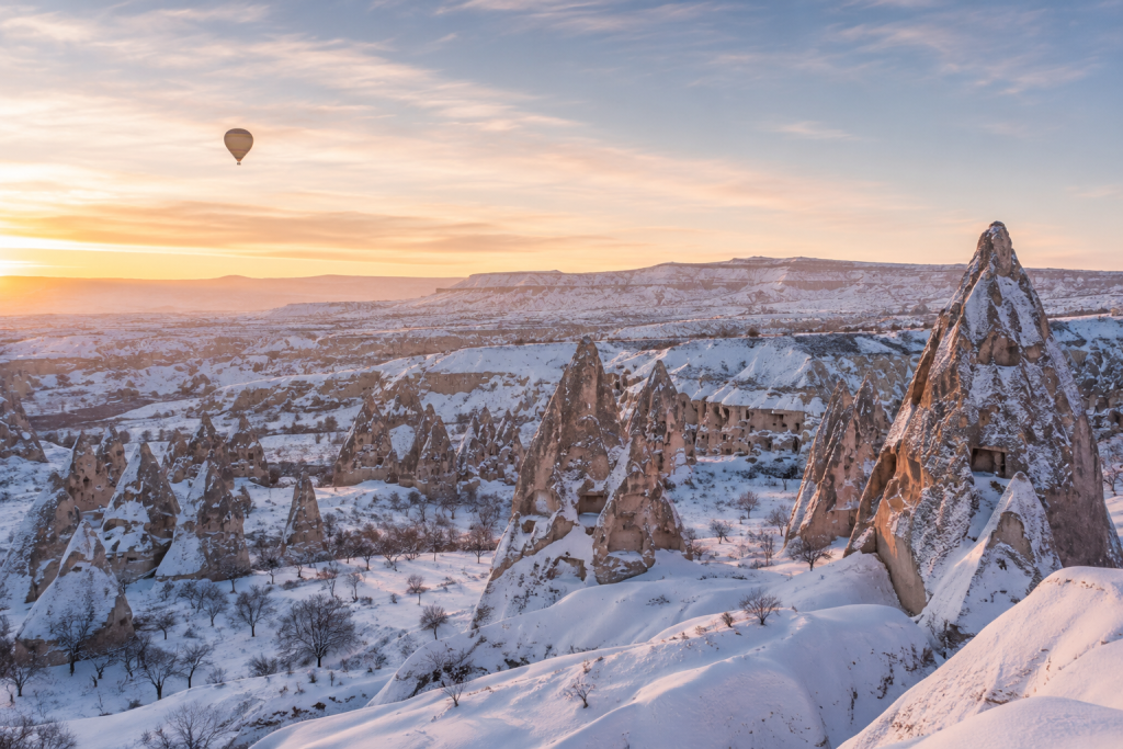 Cappadocia fairy chimneys covered in snow during winter in Turkey