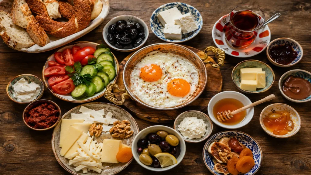 Traditional Turkish breakfast spread with cheese olives eggs tea and honey on wooden table